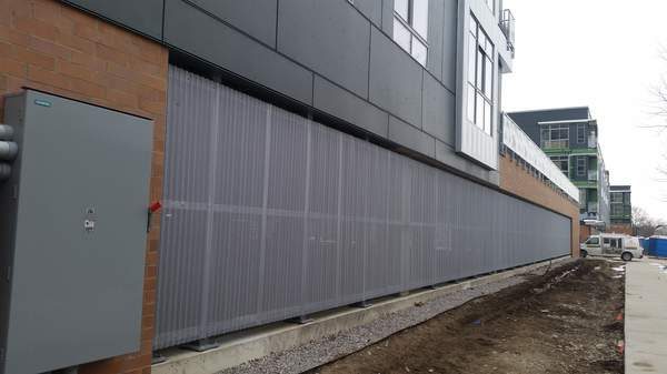 Custom perforated steel fence panels at DuCharme Place