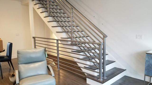 Steel floating stair handrail
