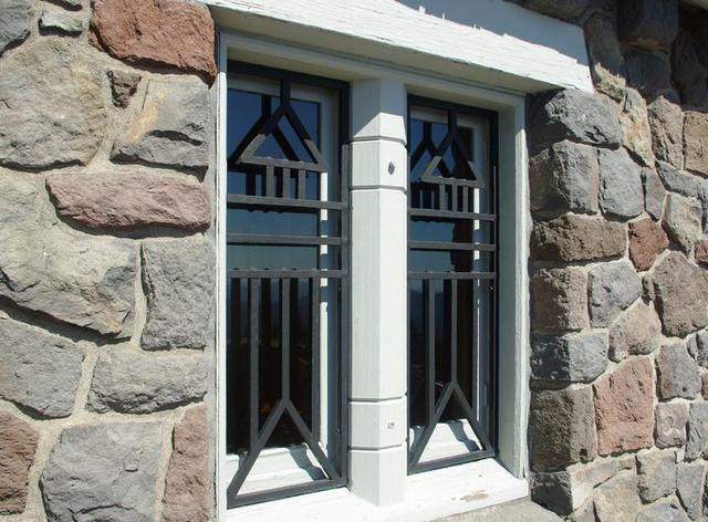 Custom metal window grille set in stone
