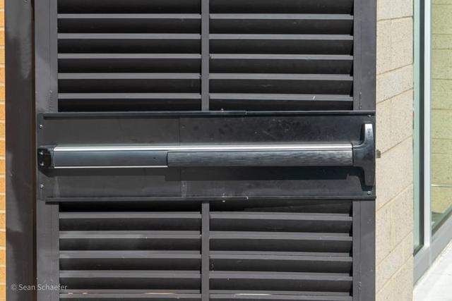 Steel AmeriLouver double-swing dumpster gates with pedestrian gate