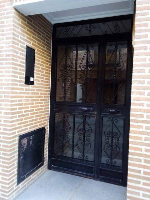 Custom metal and glass door with scrollwork