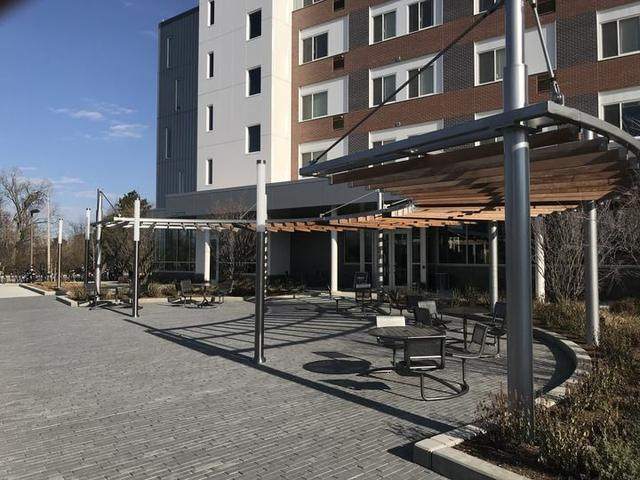 Metal and wood sun shade with tables and chairs