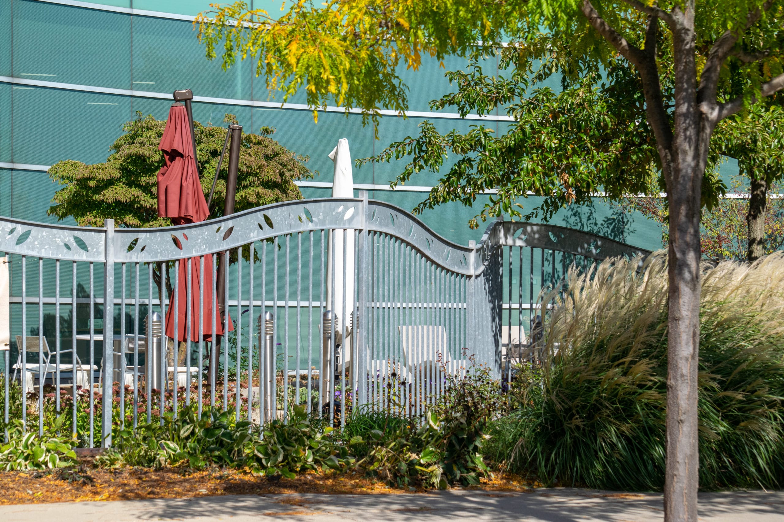 Custom laser-cut metal (galvanized steel) fence and swing gate at Warren Civic Center Library