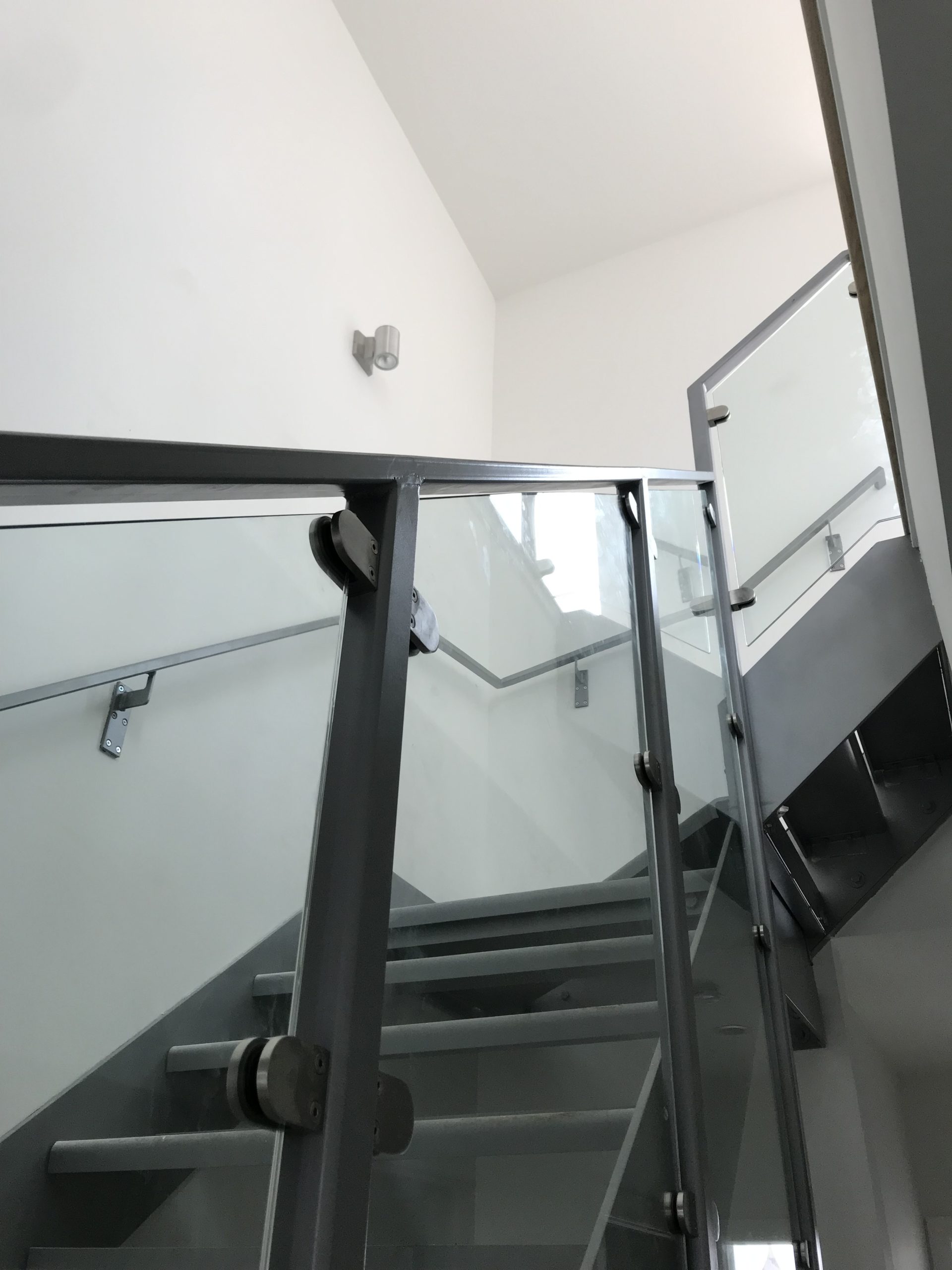 Custom metal (steel) and glass floating staircase railing (handrail) at City Modern