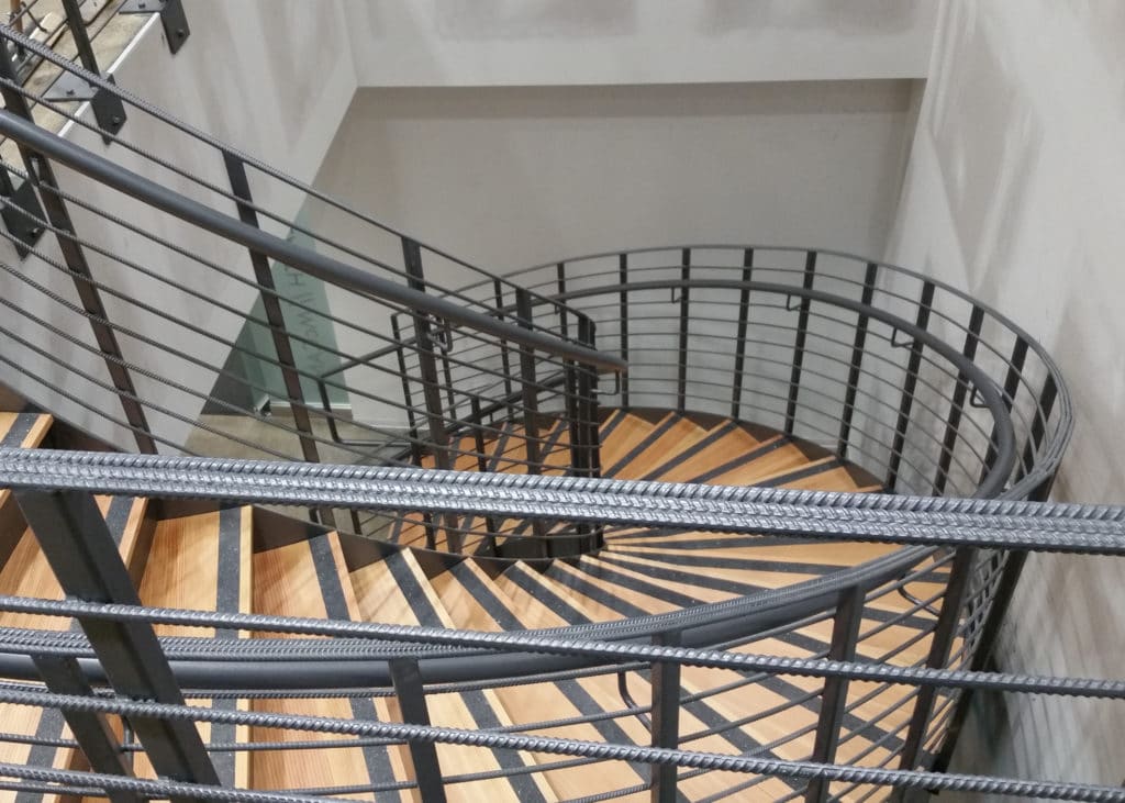 Custom metal (steel rebar) railing (spiral staircase handrail) at Commonwealth//McCann